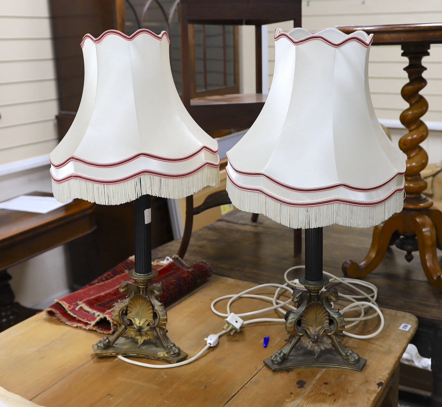 A pair of bronze table lamps, the bases cast with griffins and anthemion